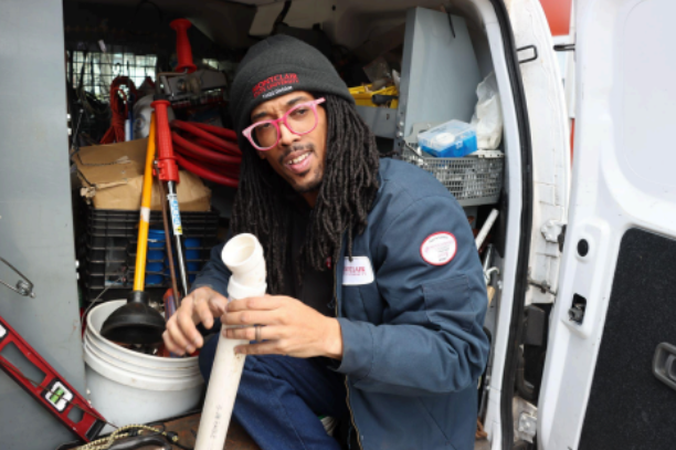 Daniel Miller going through his plumbing equipment in his van. Photo by Bryan Jaimes