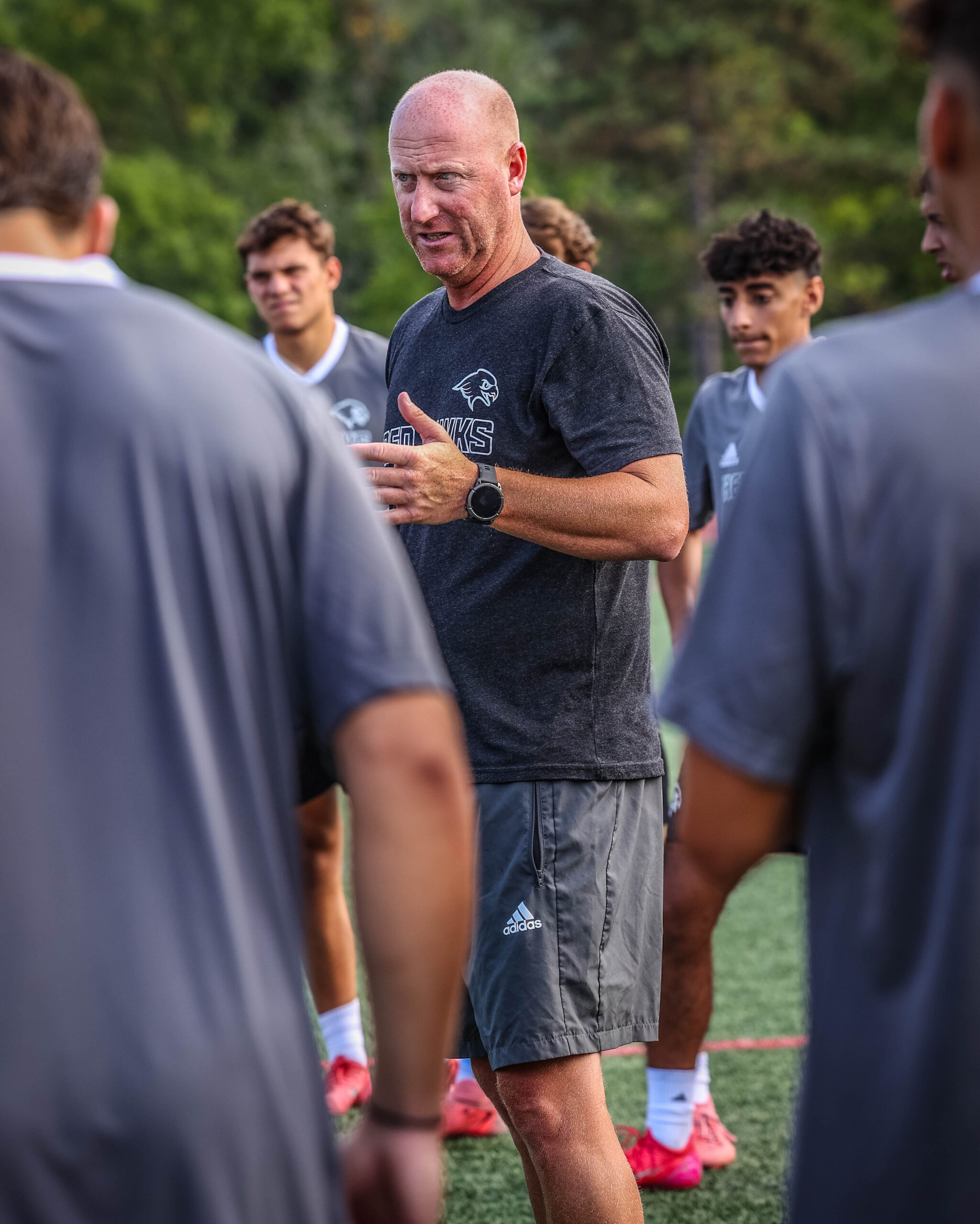 Head Coach Todd Tumelty addresses the team during a summer practice.