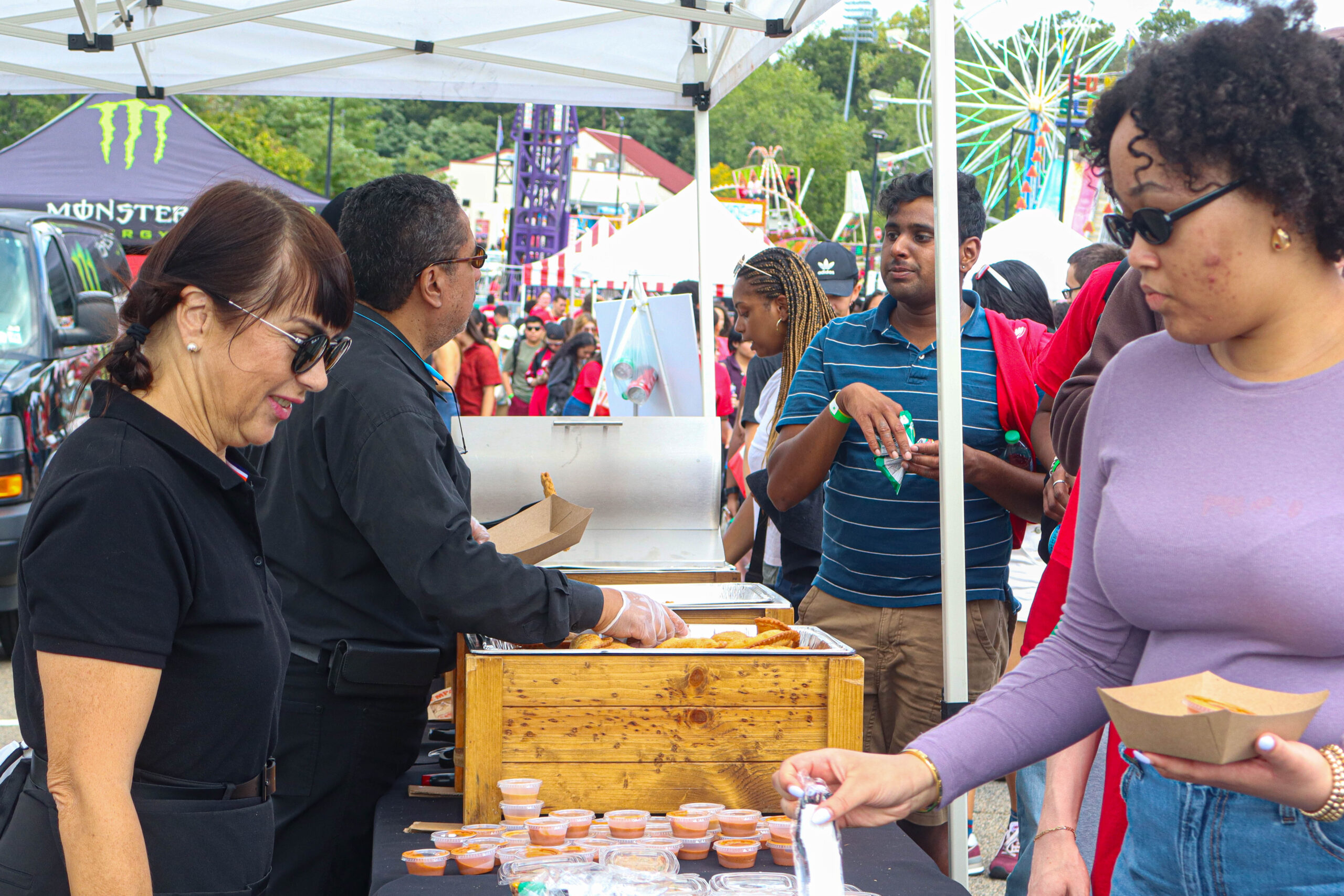 Students line up to get their empanadas and sauce during the Red Hawk Day carnival. David Bien-Aime︱The Montclarion