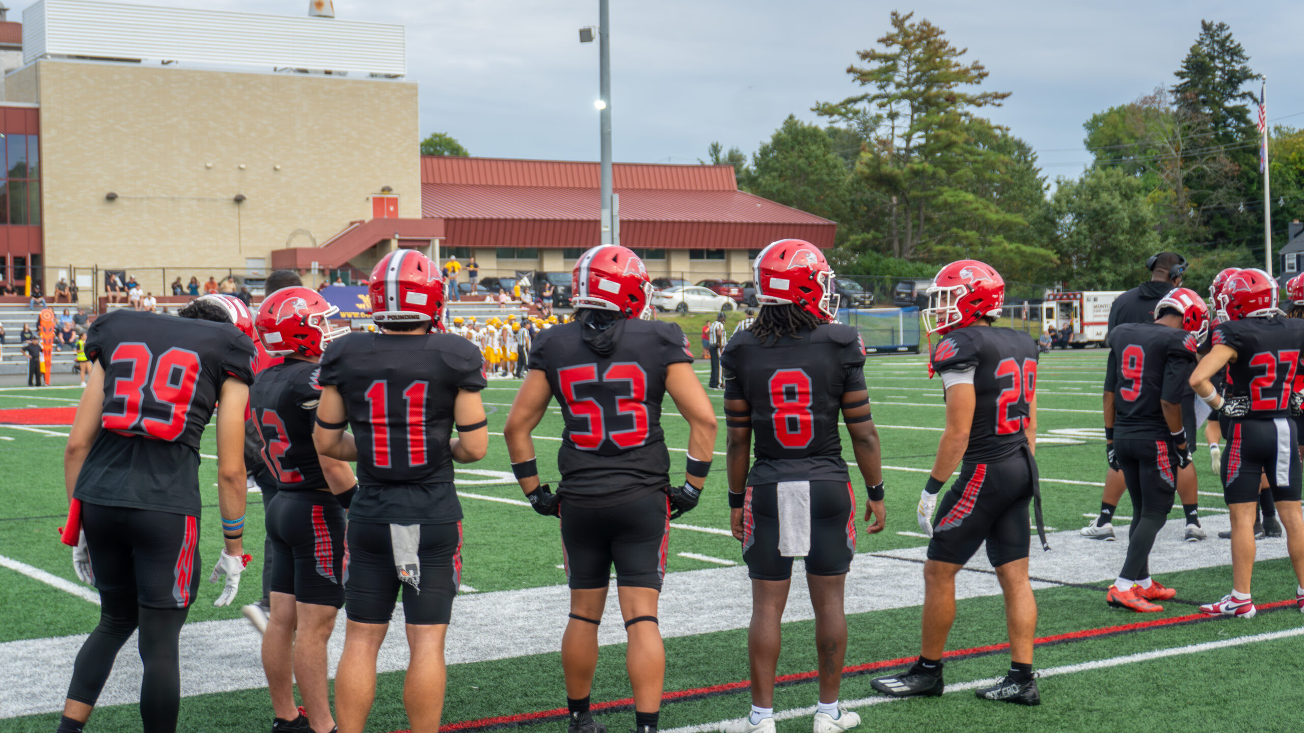 Montclair Football players eagerly watch from the sidelines.