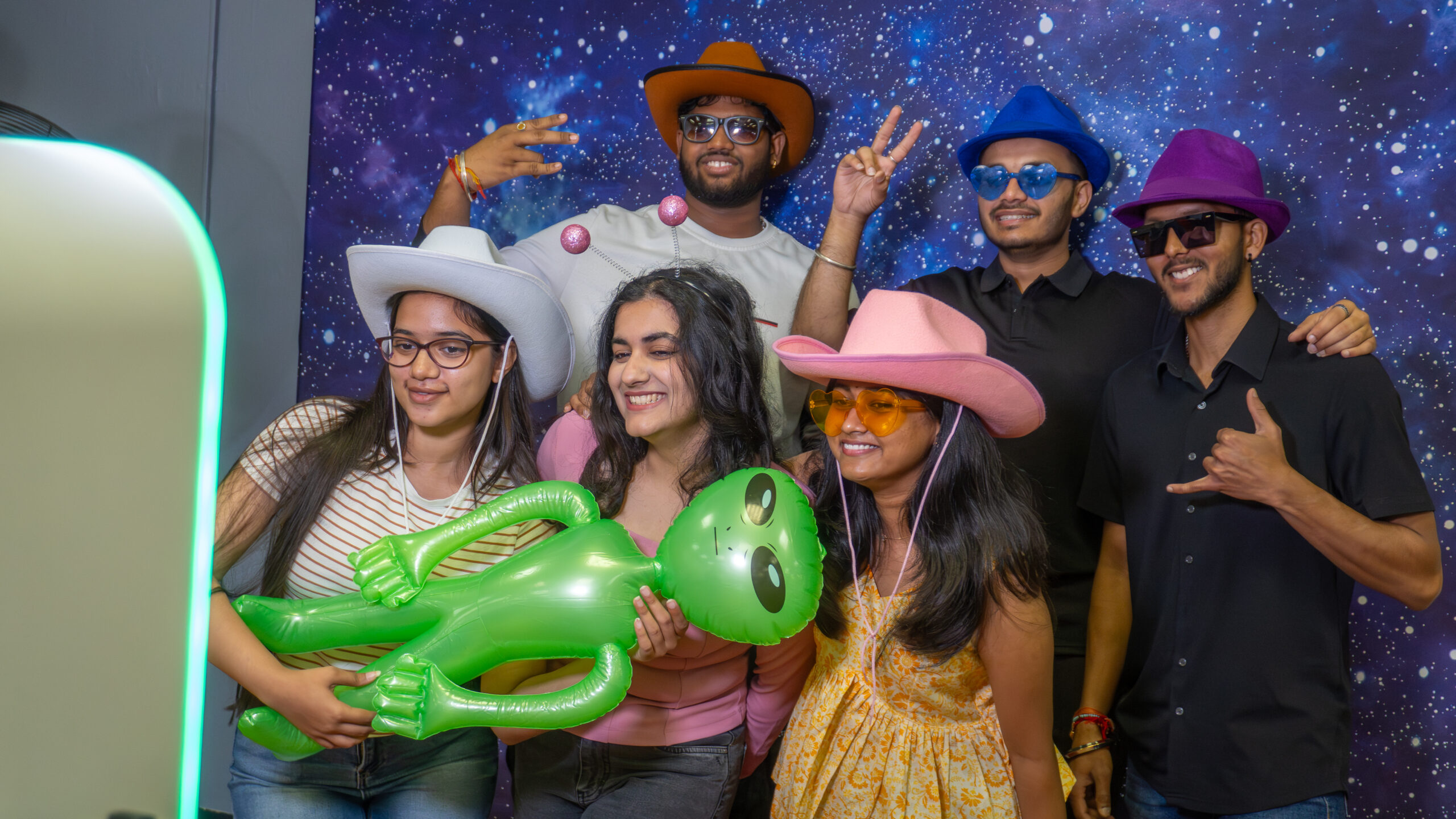 Party-goers pose at the galaxy photobooth.