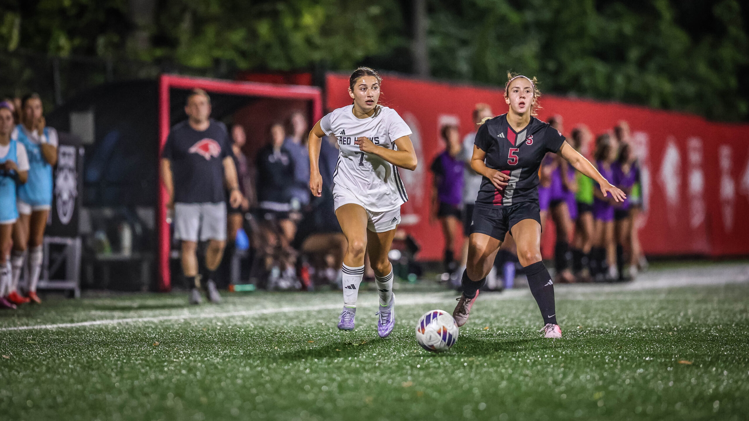 Coach Patrick Naughter watches on in the background during a September match versus Stevens.