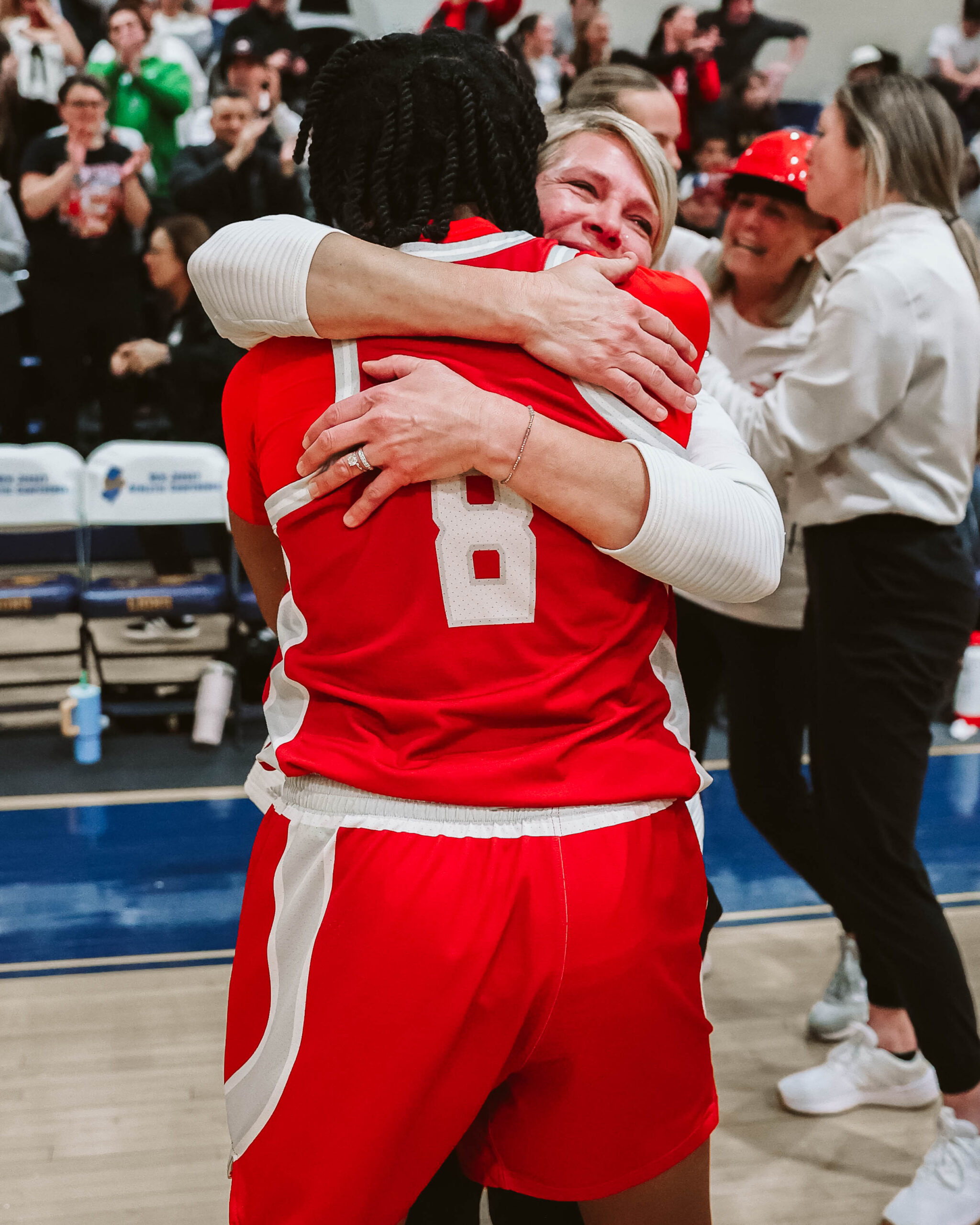 Montclair State women's basketball head coach Karin Harvey embraces Alyssa Craigwell following the Red Hawks' NJAC championship in March of 2025. Photo courtesy of Montclair State Athletics