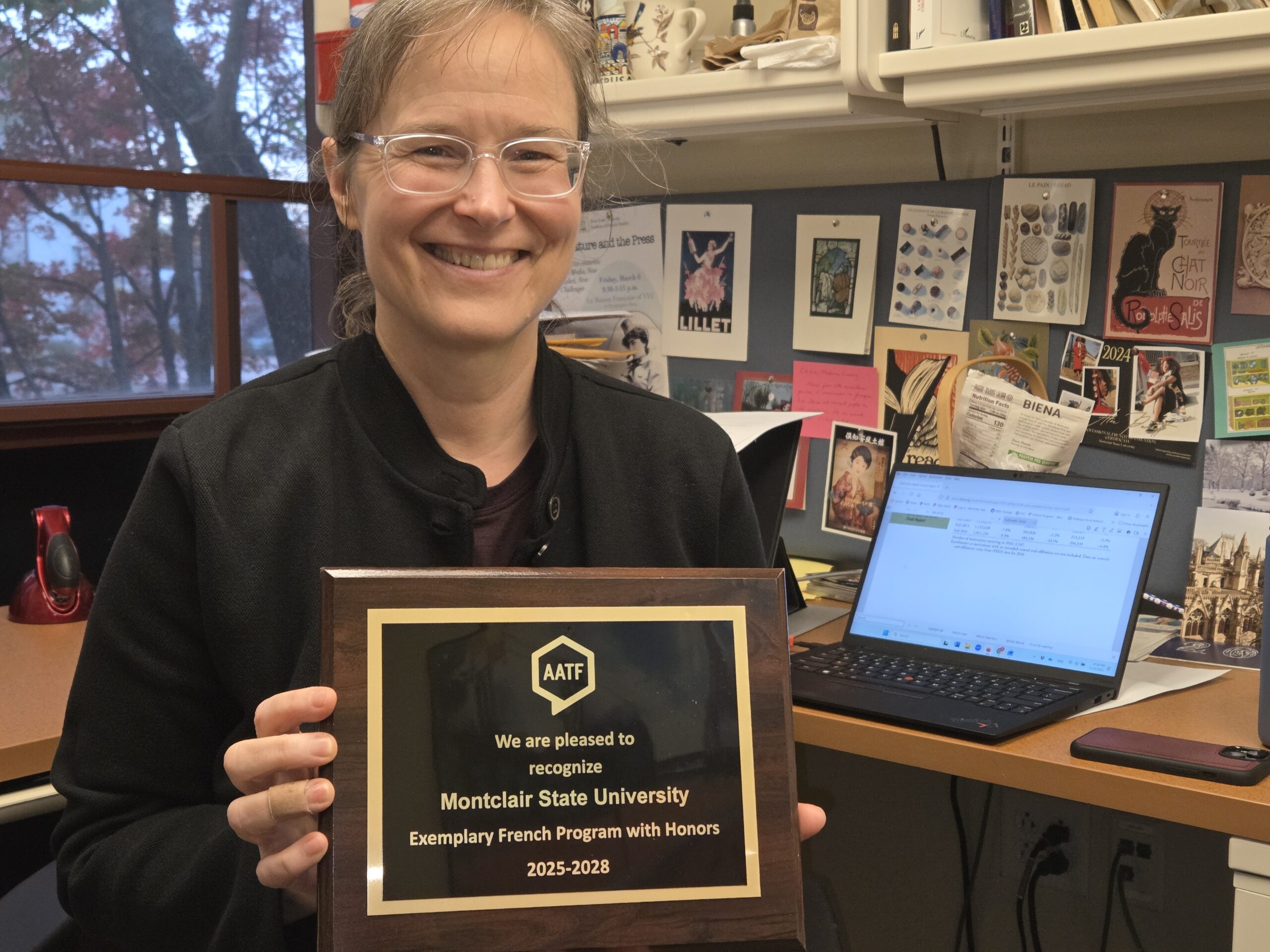 Dr. Elizabeth Emery, World Languages And Cultures French professor, displays the Exemplary French Program With Honors plaque awarded by the American Association Of Teachers of French.