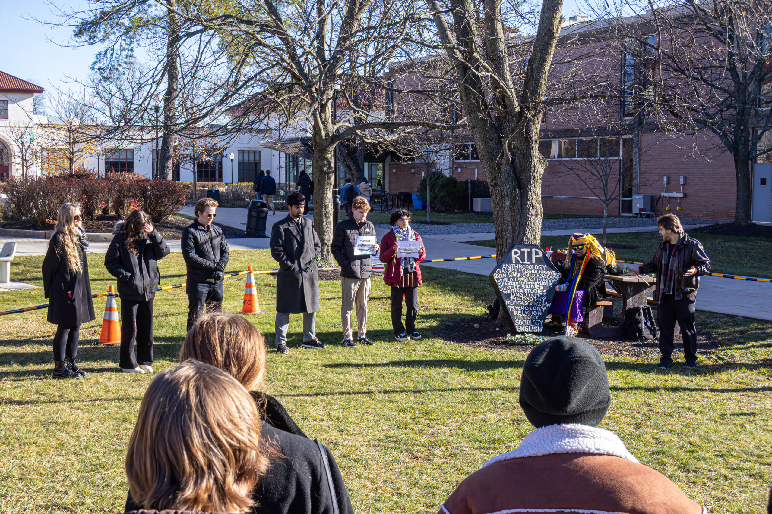 Students staged a mock funeral for the College of Humanities and Social Sciences, citing the university's restructuring plan as the beginning of the end for the beloved programs. David Bien-Aime | The Montclarion