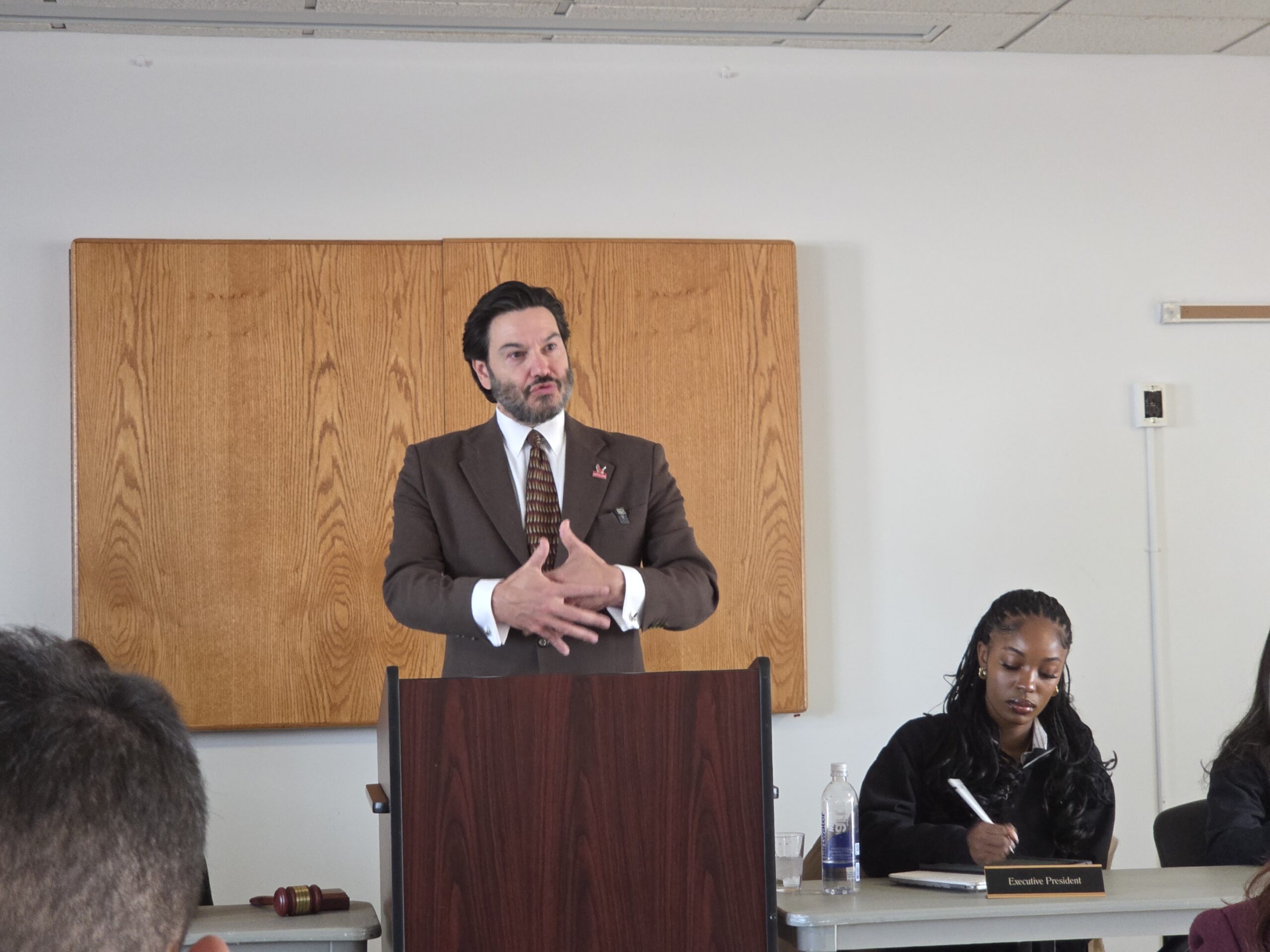 Dr. Jonathan Koppell, university president, discusses the College of Humanities And Social Sciences restructuring, while Leila Jones, student government association president, (right) takes notes.