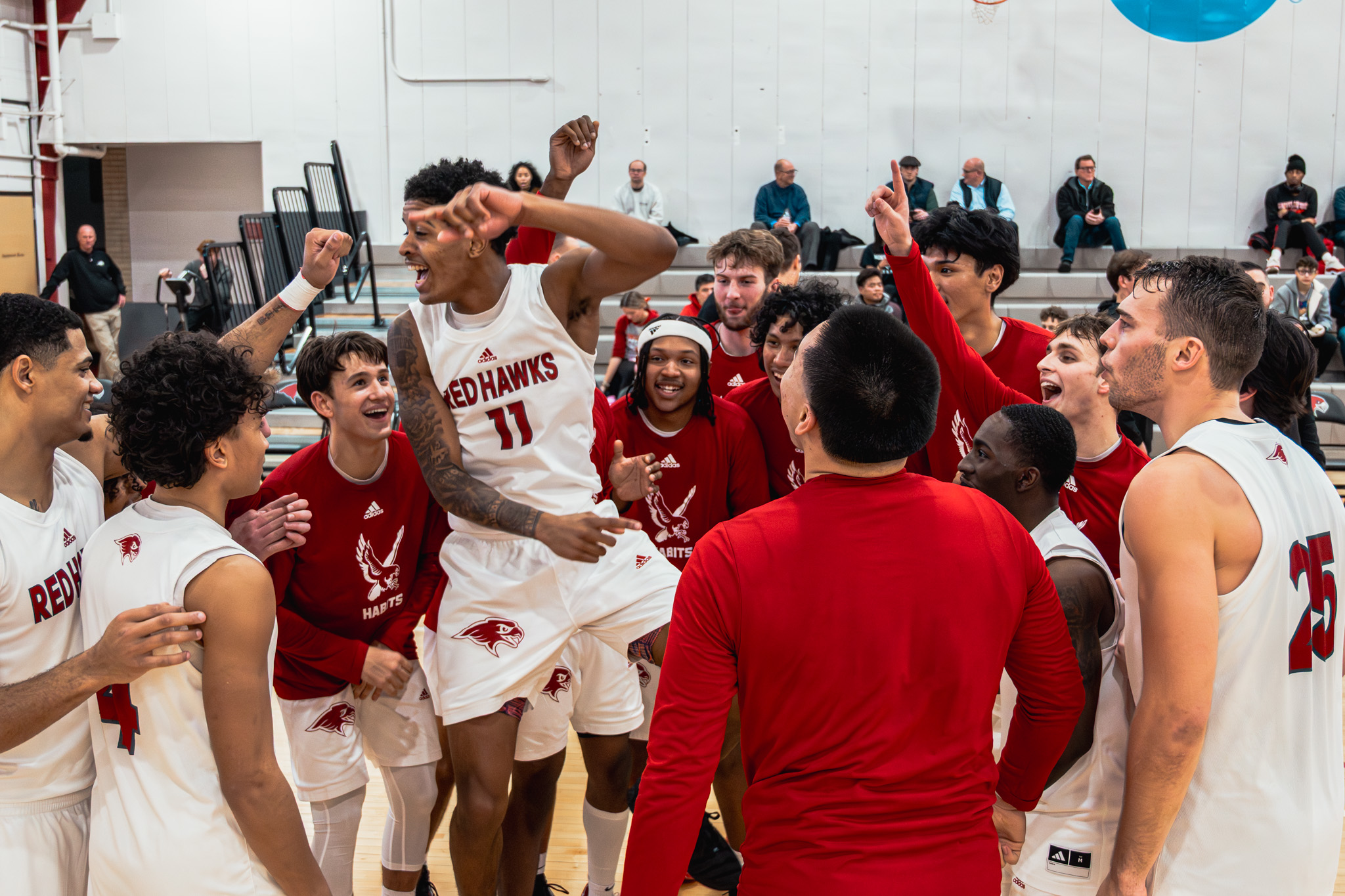 Montclair State men's basketball celebrates during a record-setting fifteenth consecutive win to begin the season. The Red Hawks are ranked eighth in the NCAA Division III poll, per d3hoops.com. Owen Klasey | The Montclarion