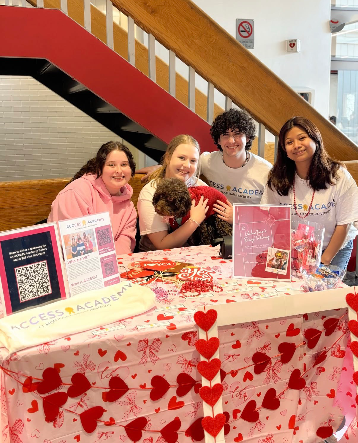 The "ACCESS Academy" team with Pebbles at their Valentine&squot;s Day tabling event.