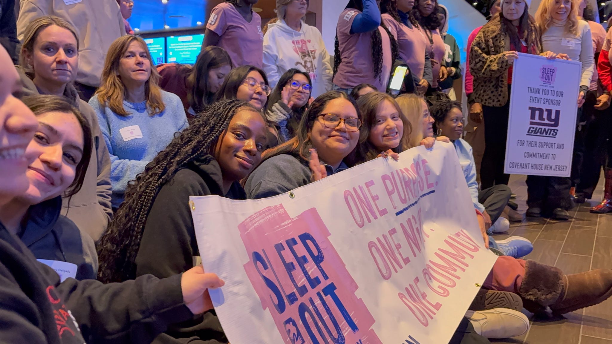 Students passionately holding a sign at the Covenant House.