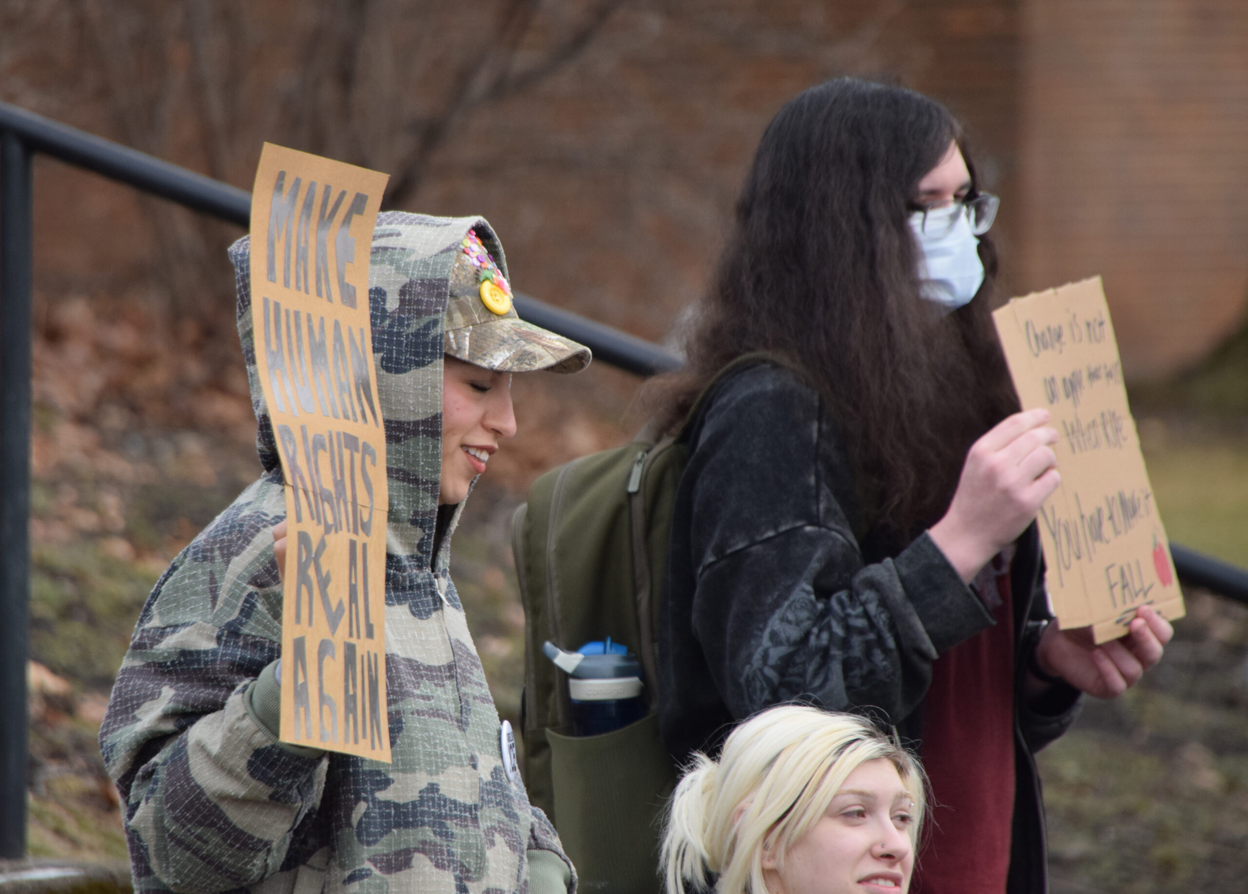 Montclair State students holding signs as people are giving speeches. Photo courtesy of Holden Holland