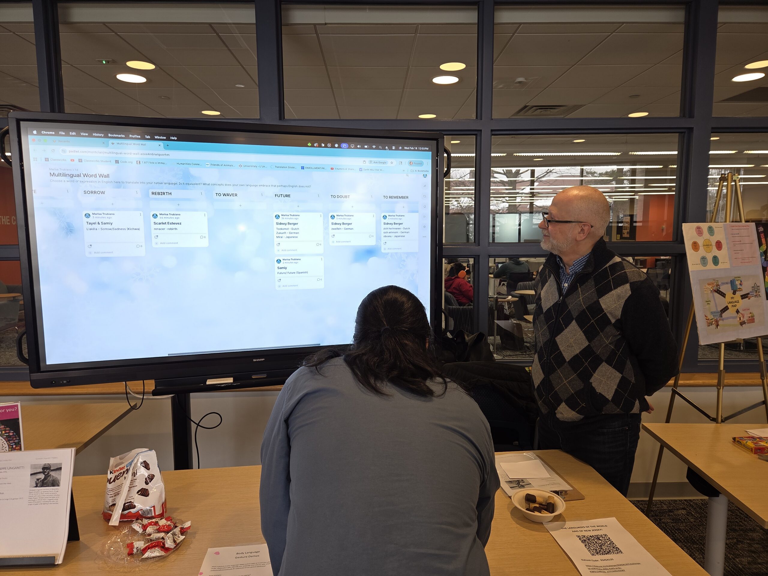 Dr. Andrea Dini, Department of World Languages And Cultures Italian professor, tends to the interactive translation wall at the Feb 18 My Language Is My Superpower seminar in the Sprague Library's first floor reading room.