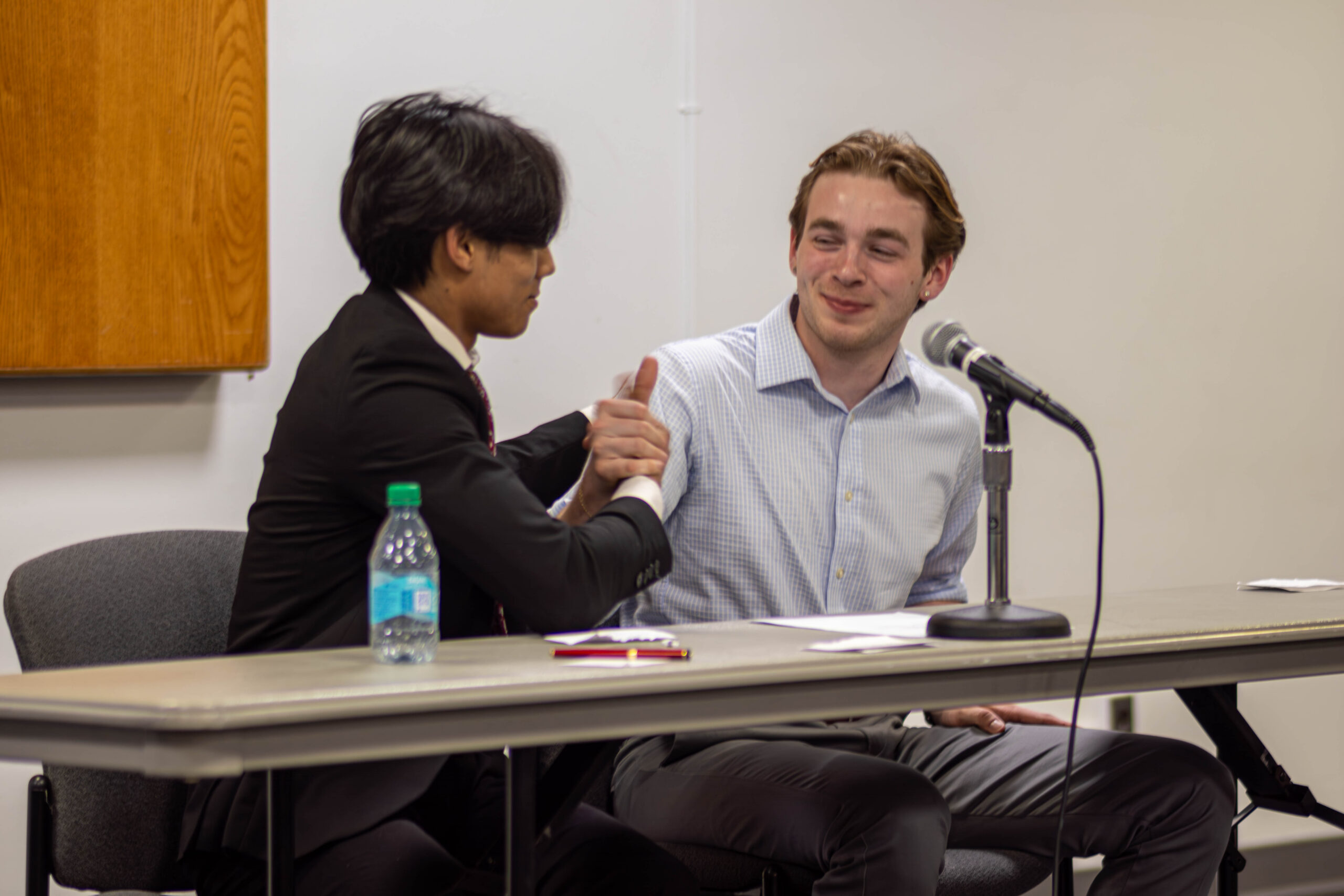 Quentin Ocampo (left) and Ben Coulson (right) shaking hands during the SGA Q&A forum.