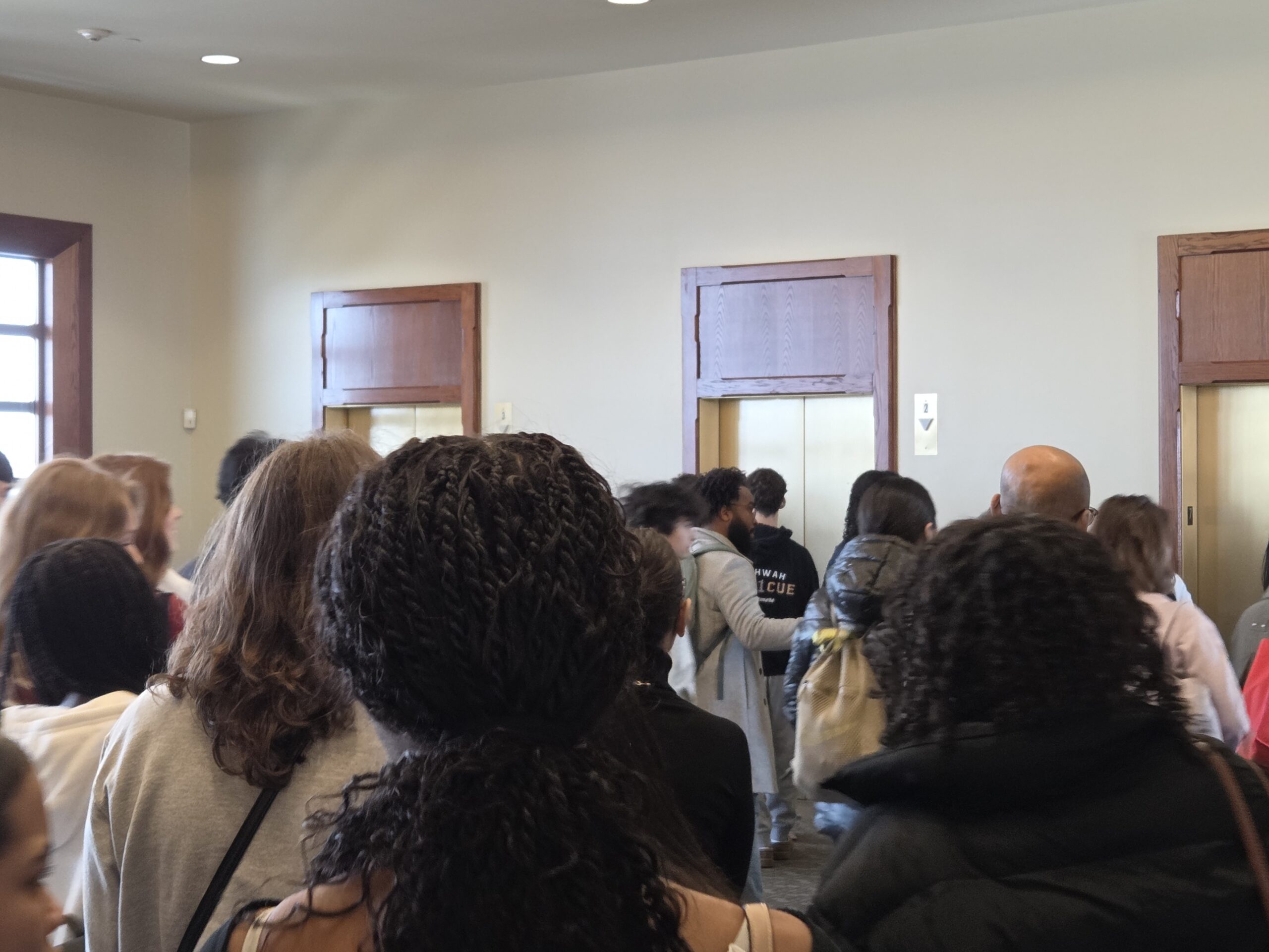 High school students head to the elevators en route to French workshops after attending French Day orientation at University Hall's seventh floor Conference Center.