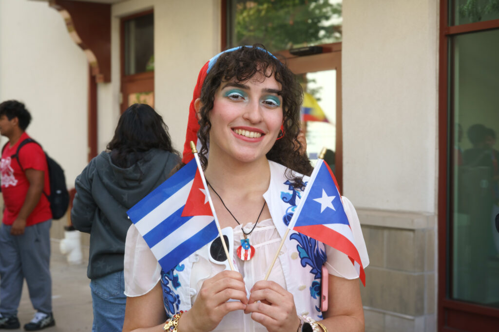 Isabela Cruz poses for a photograph with a Cuban and Puerto Rican flag, Wednesday, Sep. 16, 2026.