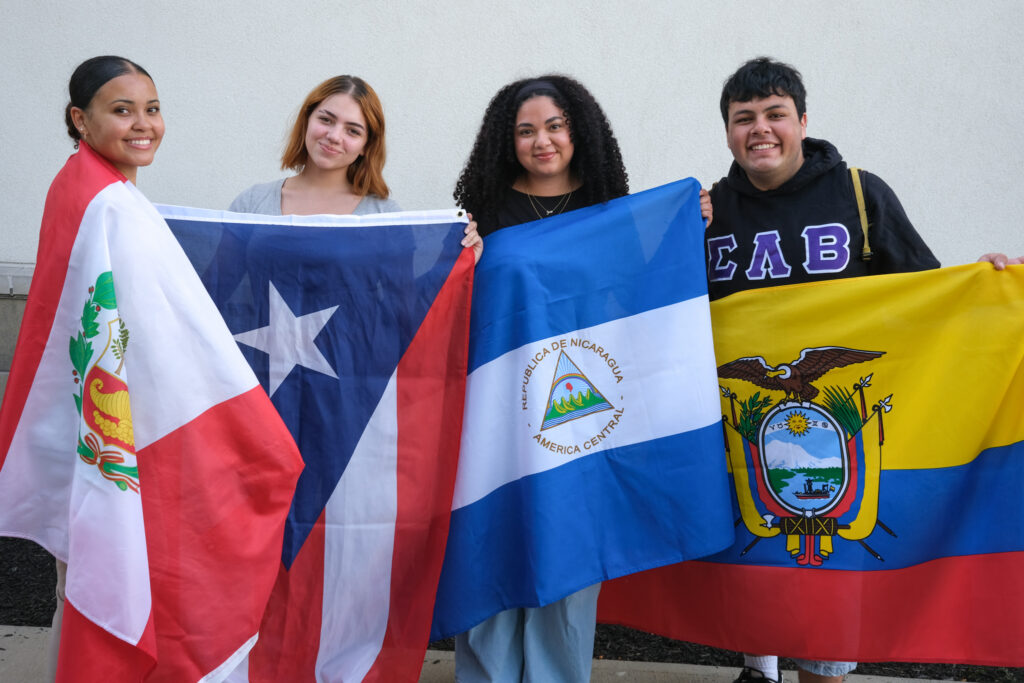 Students posing for a photograph while proudly displaying their flags, Wednesday, Sep. 16, 2026.
