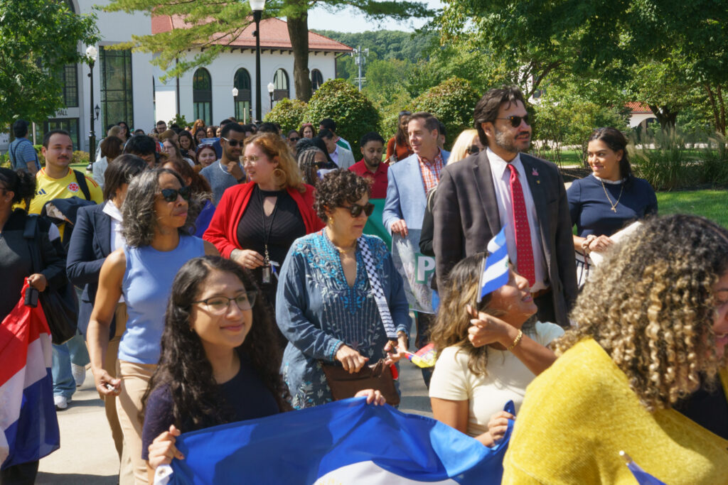 Students and staff members making their way towards the Student Center displaying their flags, Wednesday, Sep. 16, 2026.