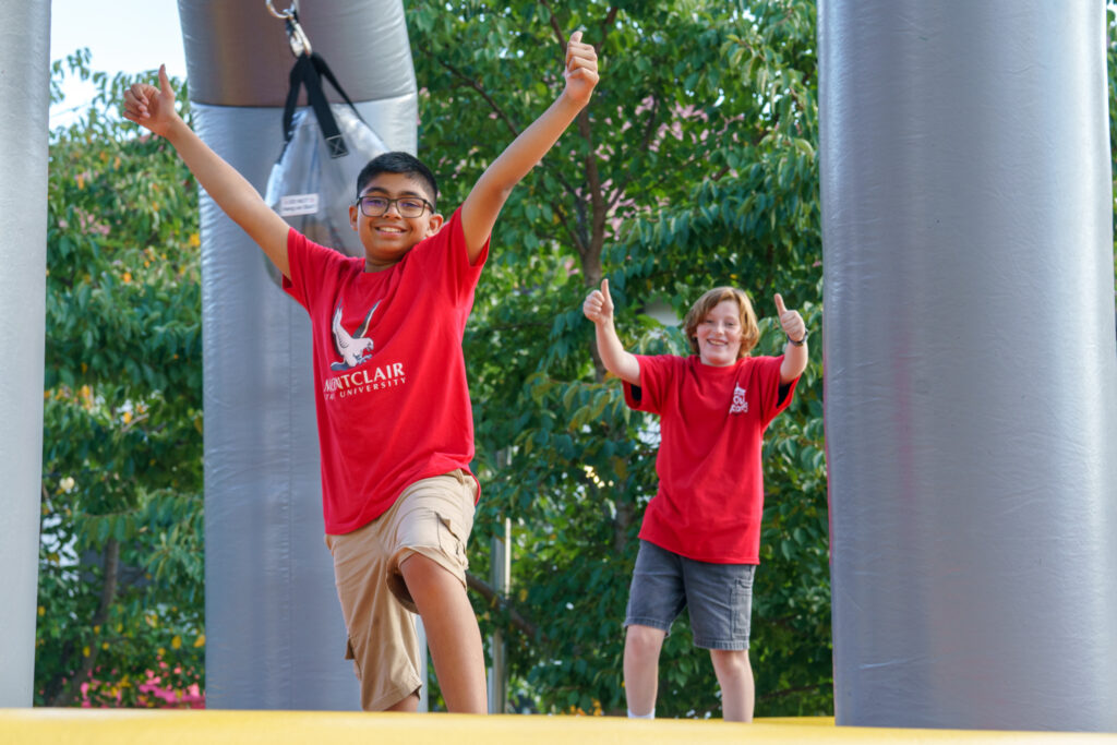 Kids briefly posing for a photograph while they play in a bounce house, Saturday, Oct. 3, 2026.