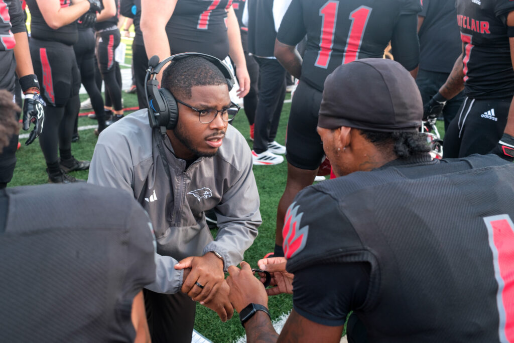 Assistant Coach Jordan Stewart encouraging Wide Receiver Khalil Forbes during the homecoming football game, Saturday, Oct. 3, 2026.