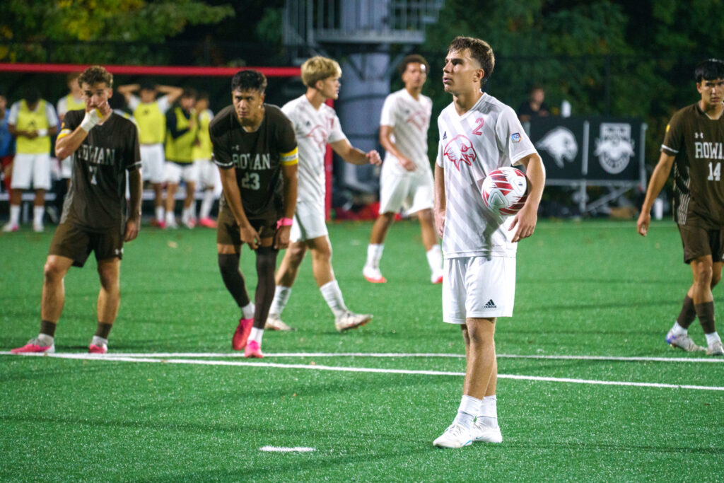 Junior defender Sebastian Lapczynski lines up for a penalty kick against rival Rowan. He converted for his fourth goal of the season, temporarily putting the Red Hawks ahead 2-1. Jamiel Negron | The Montclarion