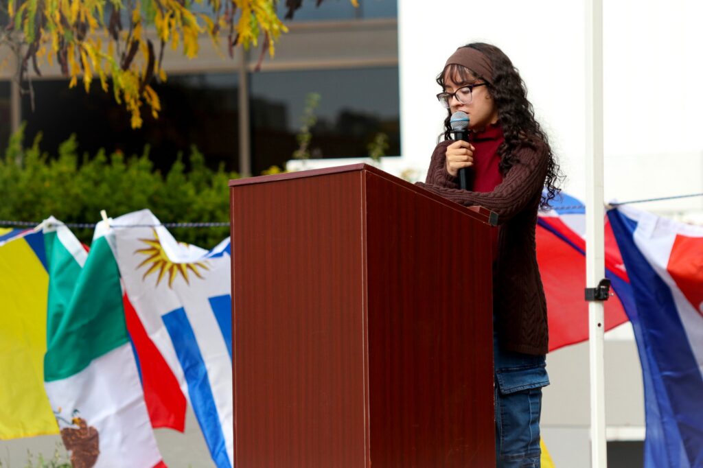 MONTCLAIR, NJ. 10-14-2026. HISPANIC HERITAGE MONTH BLOCK PARTY - SPEAKER: On October 14th 2026, a group of speakers came up to the podium to give a speech about Hispanic Heritage Month in the quad of Montclair State University. They took part in making the block party possible and one of the speakers seen in the photo is named Sarah Alexandra Rivera, President of the Puerto Rican Student Association. Photograph taken by Estefano Quispe.